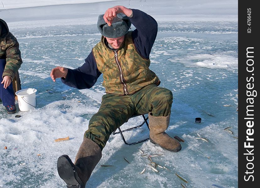 A winter fishing on river. People is fishing the smelt. Russian Far East, Primorye, Kievka river. A winter fishing on river. People is fishing the smelt. Russian Far East, Primorye, Kievka river.