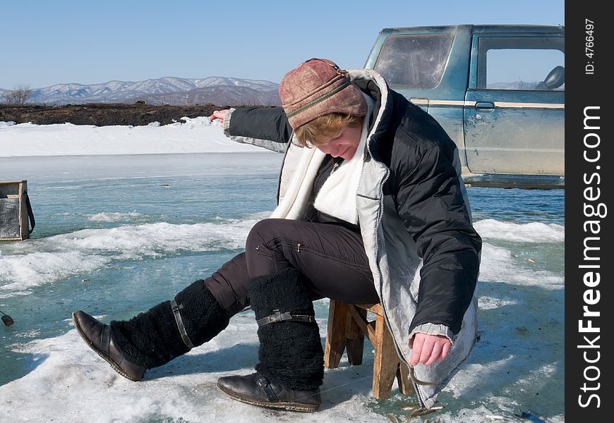 A winter fishing on river. People is fishing the smelt. Russian Far East, Primorye, Kievka river.