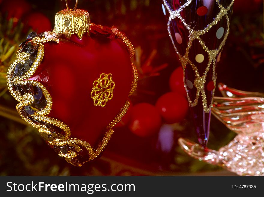 Red heart shaped christmas ornament hanging from tree