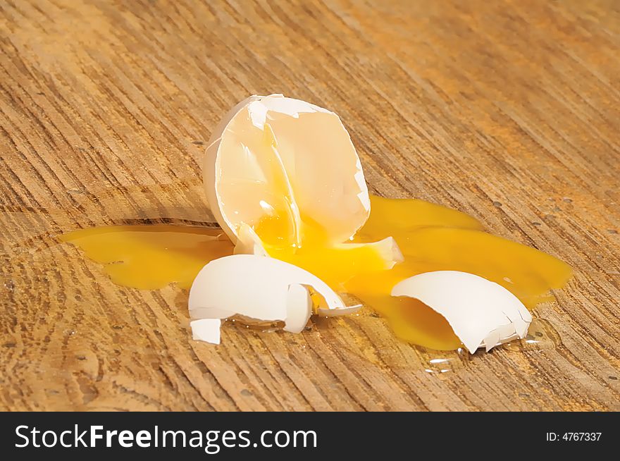 Broken egg in the wooden floor