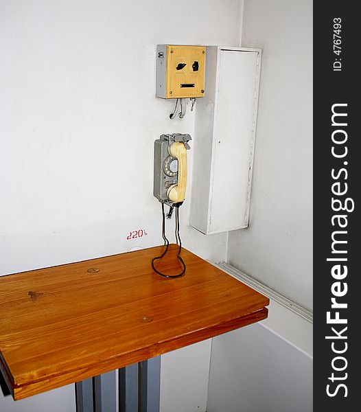 Old retro interior with a metal telephone on the wall. Old retro interior with a metal telephone on the wall
