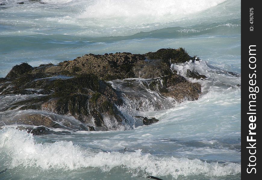 Turbulant sea crashing on a rock. Turbulant sea crashing on a rock