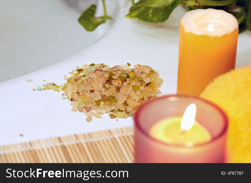 lighting yellow candles, towel, salt for home spa