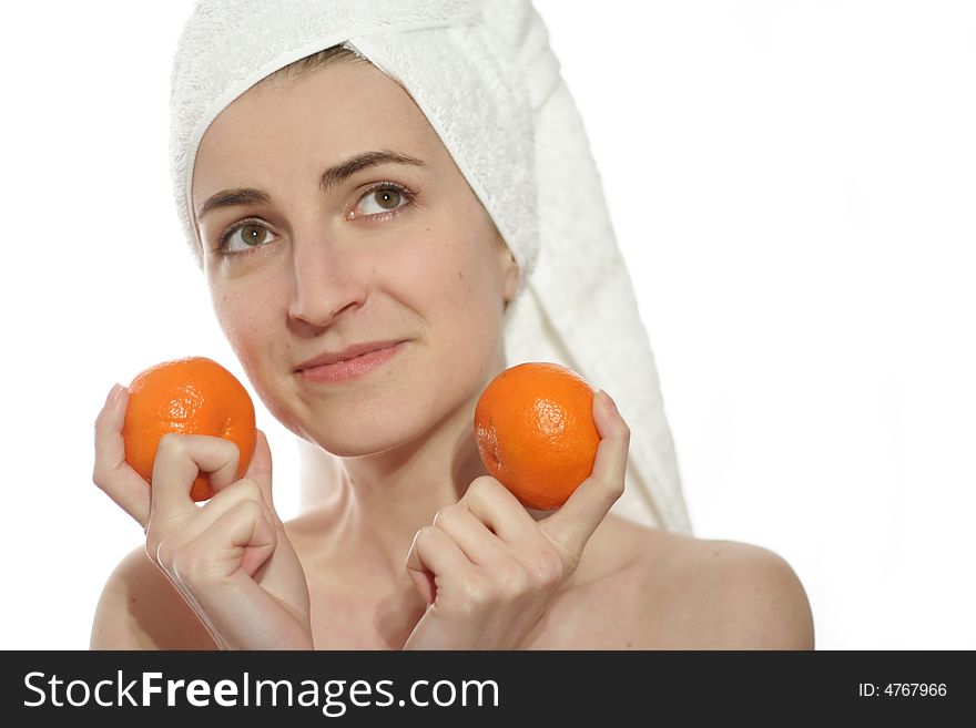 Woman with white towel holding two tangerines, isolated on white. Woman with white towel holding two tangerines, isolated on white