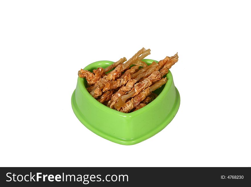 A green bowl full of dry food for dog. A green bowl full of dry food for dog