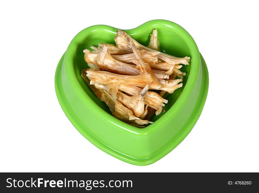 A green bowl full of dry food for dog. A green bowl full of dry food for dog