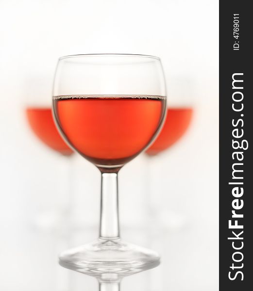 Three glasses of a red wine, symmetrical composition, shallow depth of field, please check for more. Three glasses of a red wine, symmetrical composition, shallow depth of field, please check for more