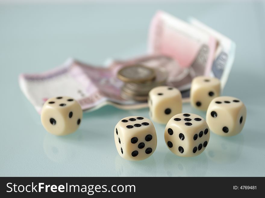 Dice and money on a white table