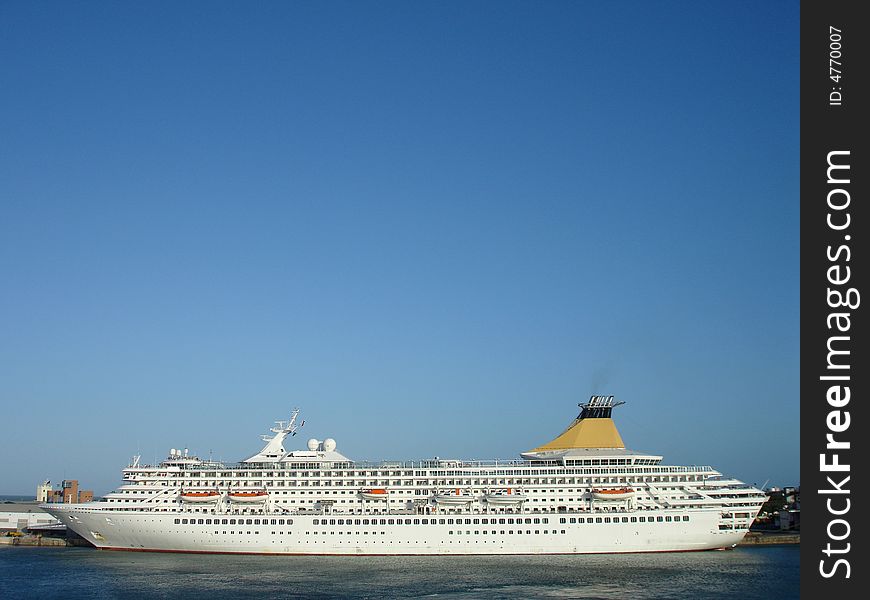 A white cruise ship at dock.