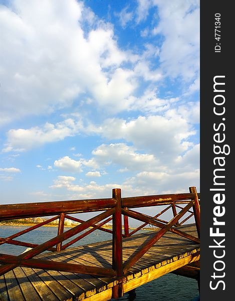 Wooden arch  bridge under the sky and clouds. Wooden arch  bridge under the sky and clouds