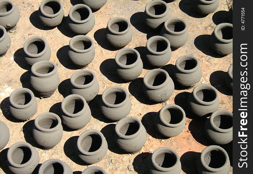 Small earthen pots kept in the sunlight