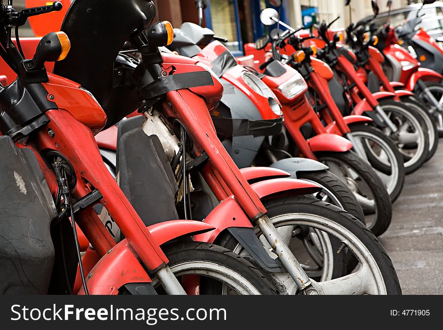 Many red motorcycles stand in a row. Many red motorcycles stand in a row
