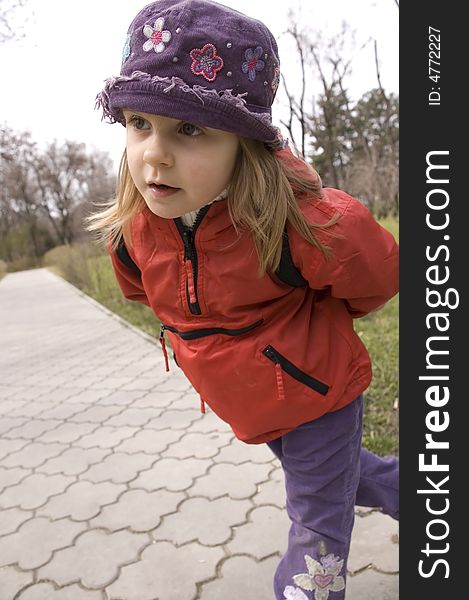 Curious little child looking carefully in the park. Curious little child looking carefully in the park