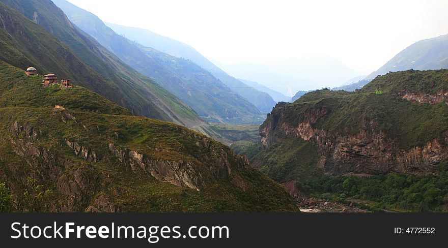 A tiny cable car daggles high above a spectacular canyon gorge near the town of Banos Ecuador. A tiny cable car daggles high above a spectacular canyon gorge near the town of Banos Ecuador