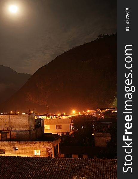 The town of Banos, Ecuador light up under a full moon. The town of Banos, Ecuador light up under a full moon