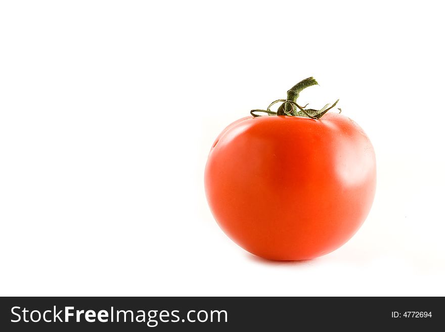 An isolated tomato over a white background.