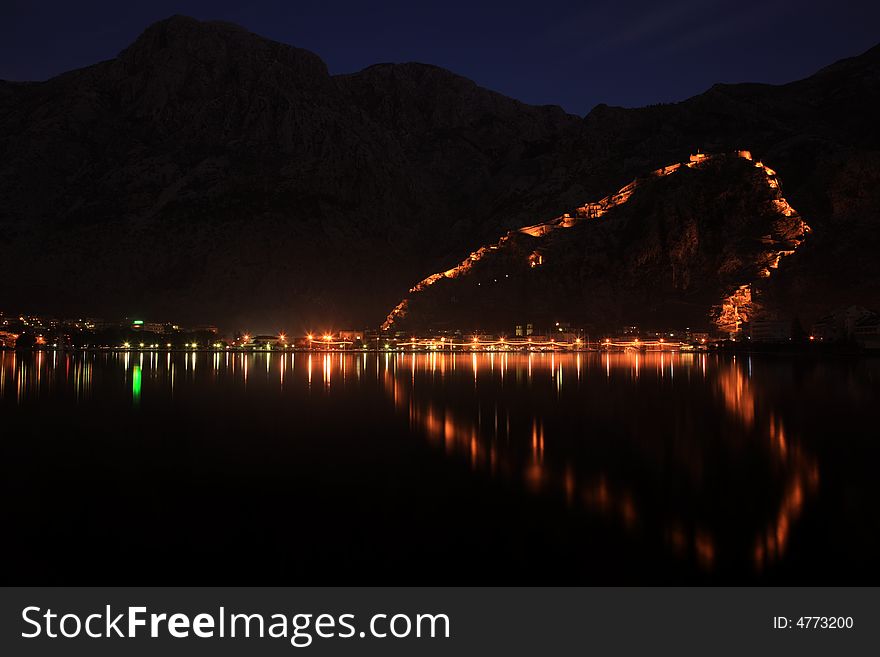 Night in Kotor, Montenegro, view across bay to fortress town.