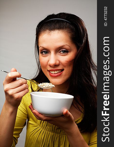Young beautiful woman with cup of muesli. Young beautiful woman with cup of muesli
