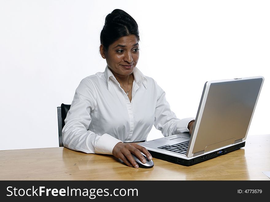 Indian woman looking shocked while working on her laptop. Indian woman looking shocked while working on her laptop