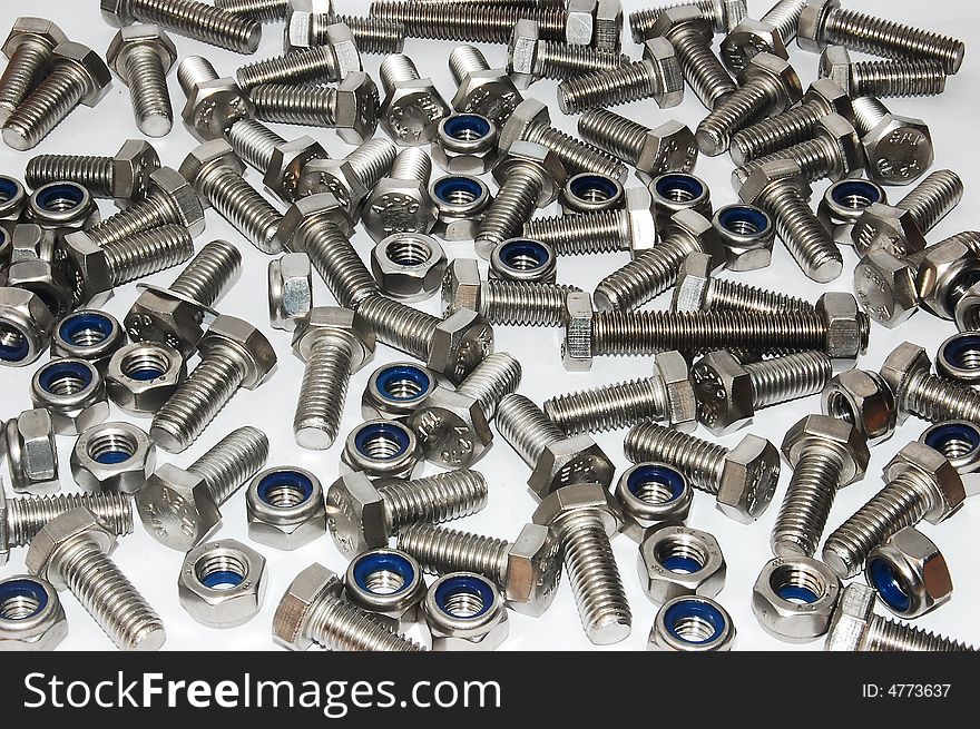 Scatterred nuts and bolts on a white background