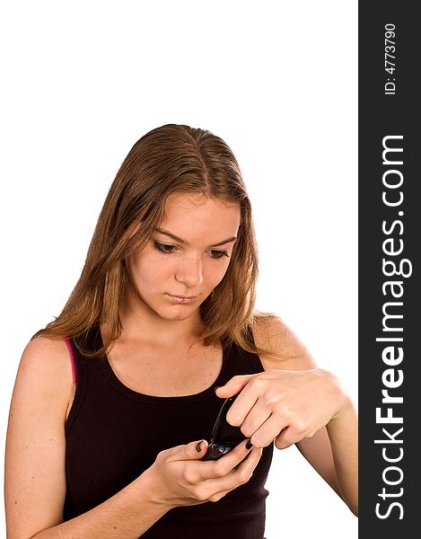 Young woman with her mobile phone flipped open looking at the screen. Young woman with her mobile phone flipped open looking at the screen