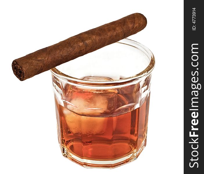 Scotch on the rocks in a glass with a cigar balanced on it. Isolated. Scotch on the rocks in a glass with a cigar balanced on it. Isolated.