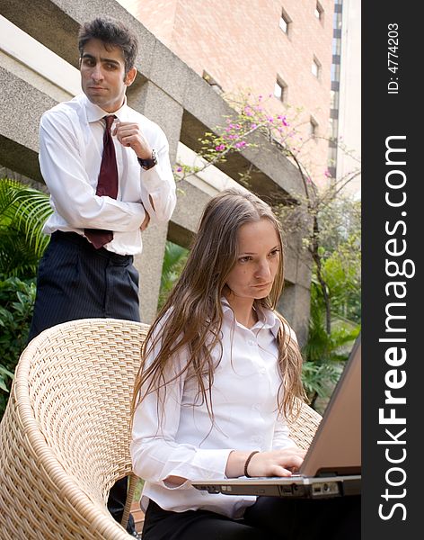 Businessman and woman looking at a laptop, with troubled expressions.