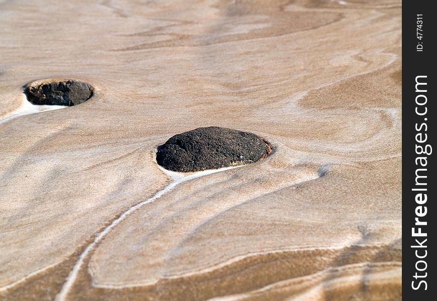 Desert sand and rock washed over by a flood, leaving the sand looking like hot breakfast ceral. Desert sand and rock washed over by a flood, leaving the sand looking like hot breakfast ceral.