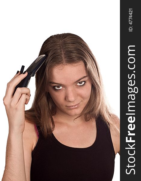 Young woman with her mobile phone flipped open held against her head. Young woman with her mobile phone flipped open held against her head