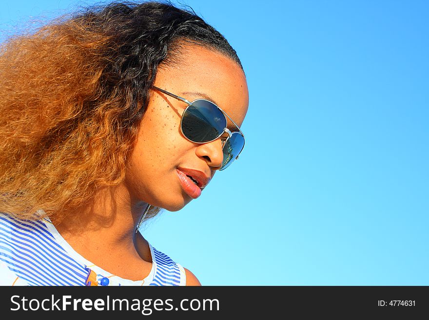 Attractive black woman wearing sunglasses.