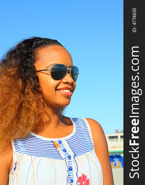 Attractive black woman wearing sunglasses.