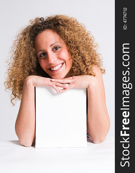 A beautiful and attractive girl holding a billboard. Ready to add your own text. Copy-space on a sign or poster. Young girl holding a sign, advertisement or poster. The concept of this picture is: copy-space on a white board or advertising. A beautiful and attractive girl holding a billboard. Ready to add your own text. Copy-space on a sign or poster. Young girl holding a sign, advertisement or poster. The concept of this picture is: copy-space on a white board or advertising.