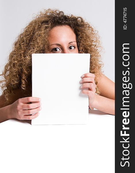 A beautiful and attractive girl holding a billboard. Ready to add your own text. Copy-space on a sign or poster. Young girl holding a sign, advertisement or poster. The concept of this picture is: copy-space on a white board or advertising. A beautiful and attractive girl holding a billboard. Ready to add your own text. Copy-space on a sign or poster. Young girl holding a sign, advertisement or poster. The concept of this picture is: copy-space on a white board or advertising.