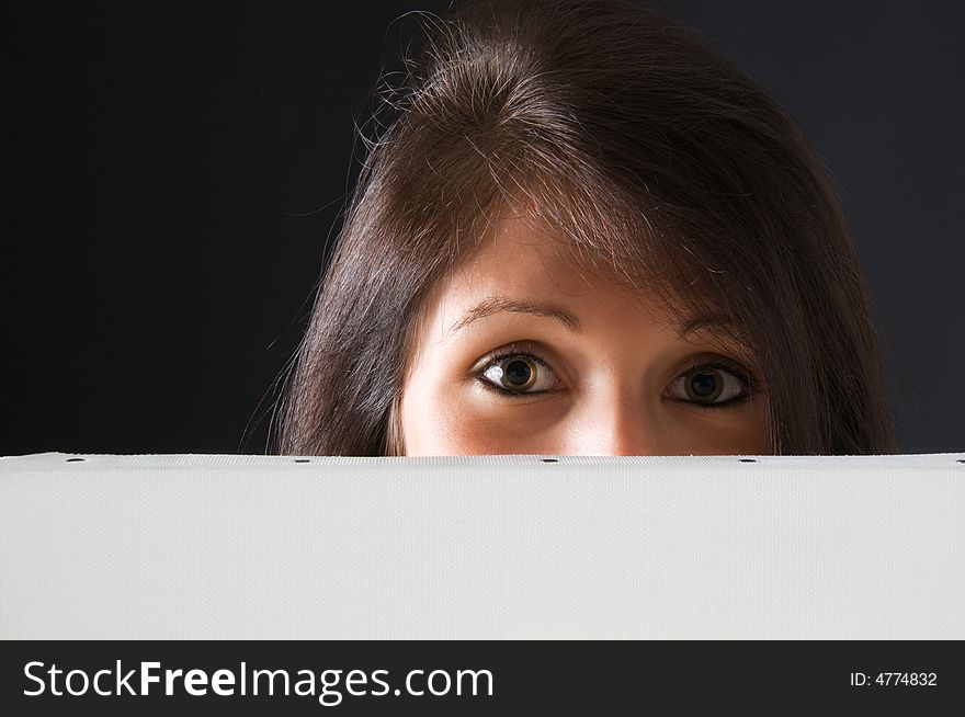 A beautiful and attractive girl holding a billboard. Ready to add your own text. Copy-space on a sign or poster. Young girl holding a sign, advertisement or poster. The concept of this picture is: copy-space on a white board or advertising. A beautiful and attractive girl holding a billboard. Ready to add your own text. Copy-space on a sign or poster. Young girl holding a sign, advertisement or poster. The concept of this picture is: copy-space on a white board or advertising.