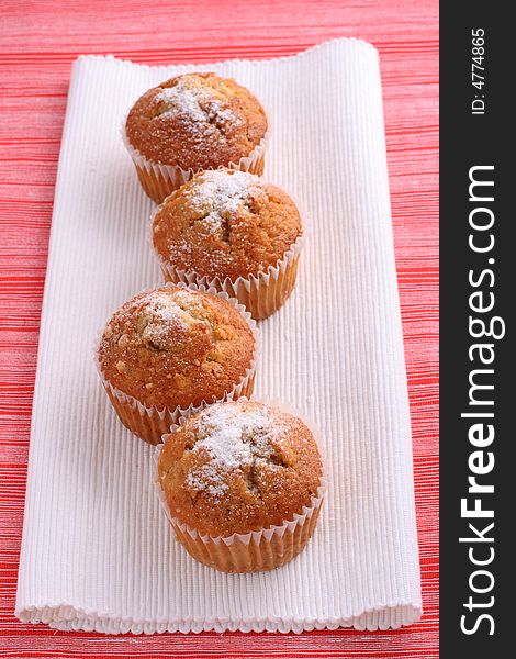 Four Cupcakes Muffins On White And Red Place Mats