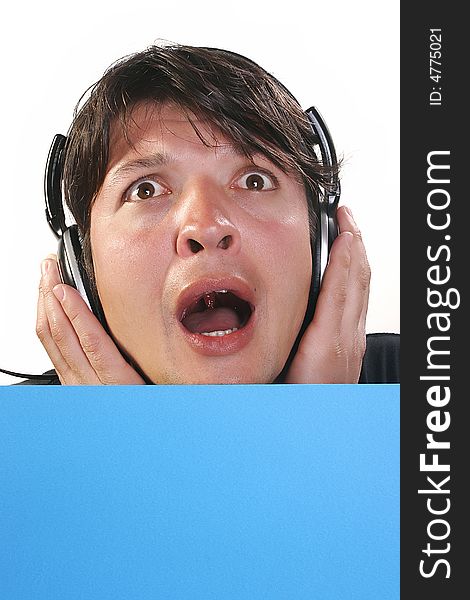 Young man with headphones and blue billboard