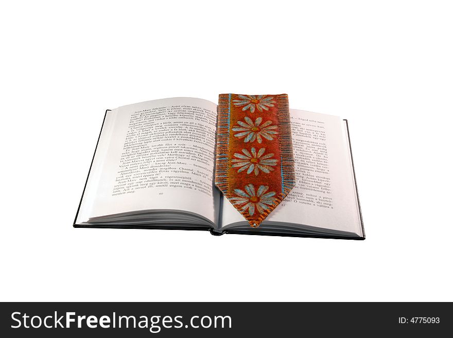 Open book with tassel against white background