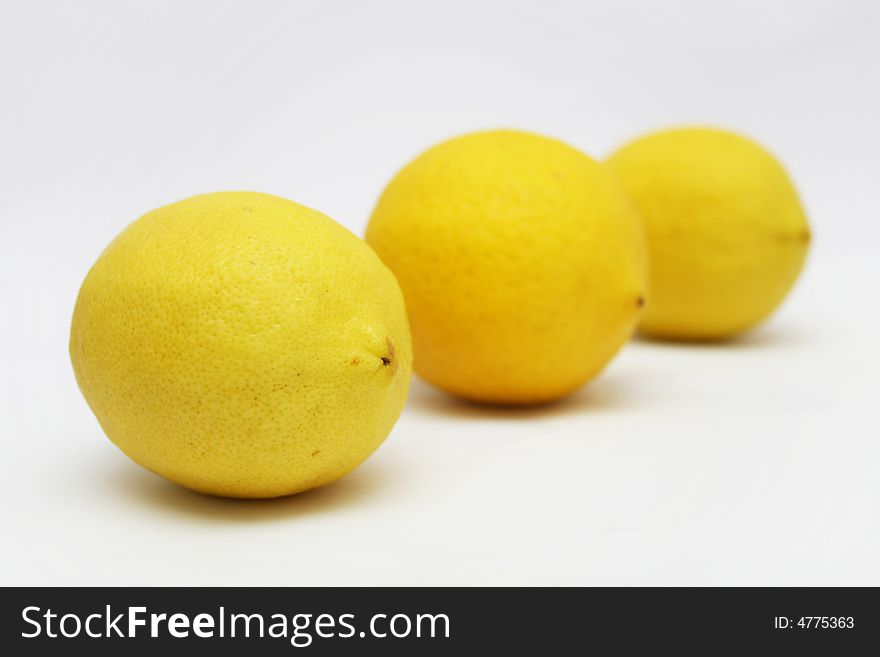 Three lemons in perspective view with white background