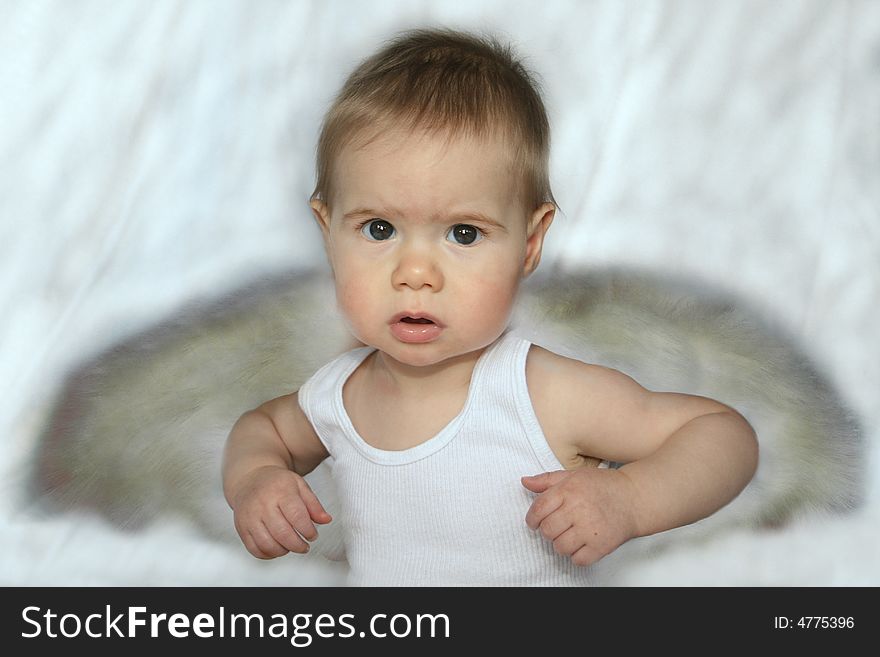 Baby in a white tank with angel wings. Baby in a white tank with angel wings
