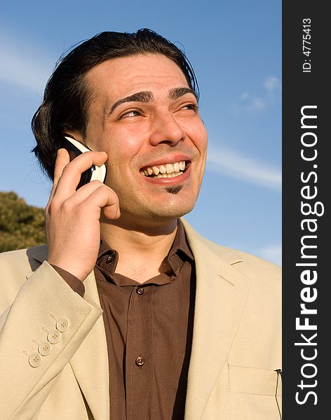 Young man with mobile phone smiling. Young man with mobile phone smiling