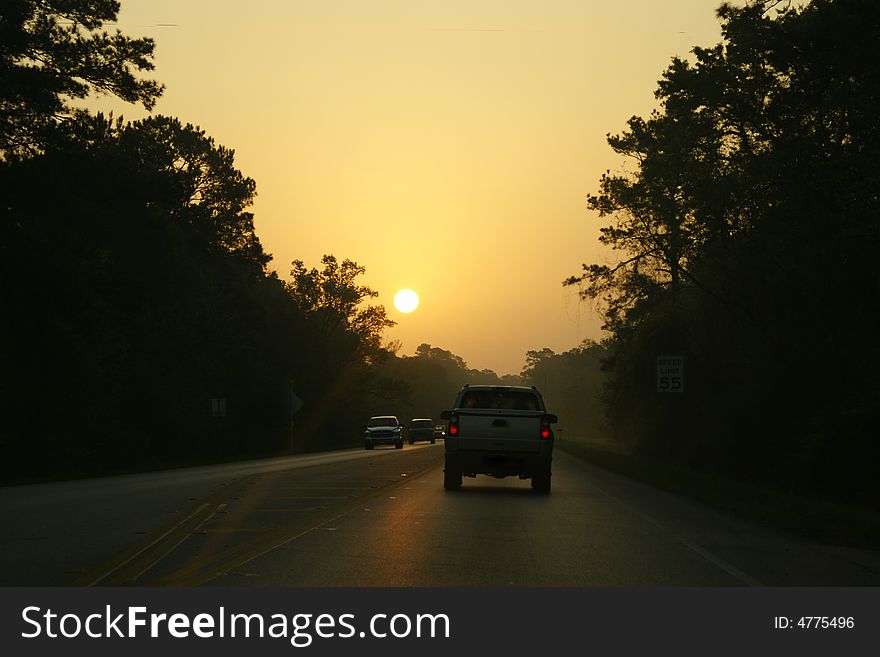 Heading down the highway while the sun rises. Heading down the highway while the sun rises