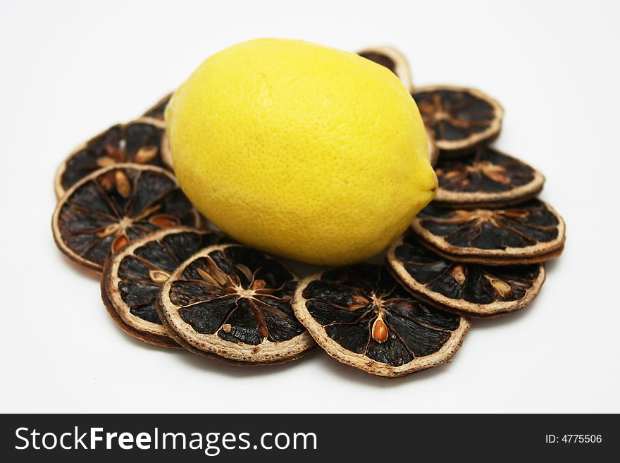 Fresh lemon stand in the middle of dried lemon slices. Fresh lemon stand in the middle of dried lemon slices