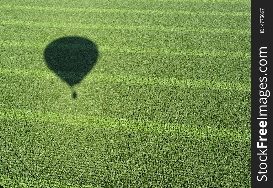 This photo is taken from a hot air balloon drifting by a farmer's field. This photo is taken from a hot air balloon drifting by a farmer's field