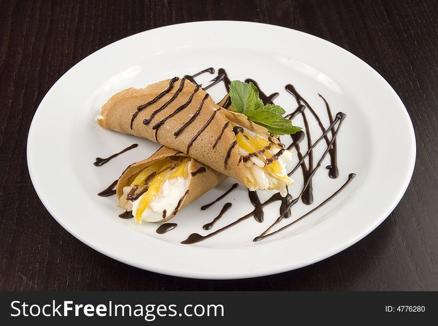 Pancakes with fruit, whipped cream in chocolate. Pancakes with fruit, whipped cream in chocolate.