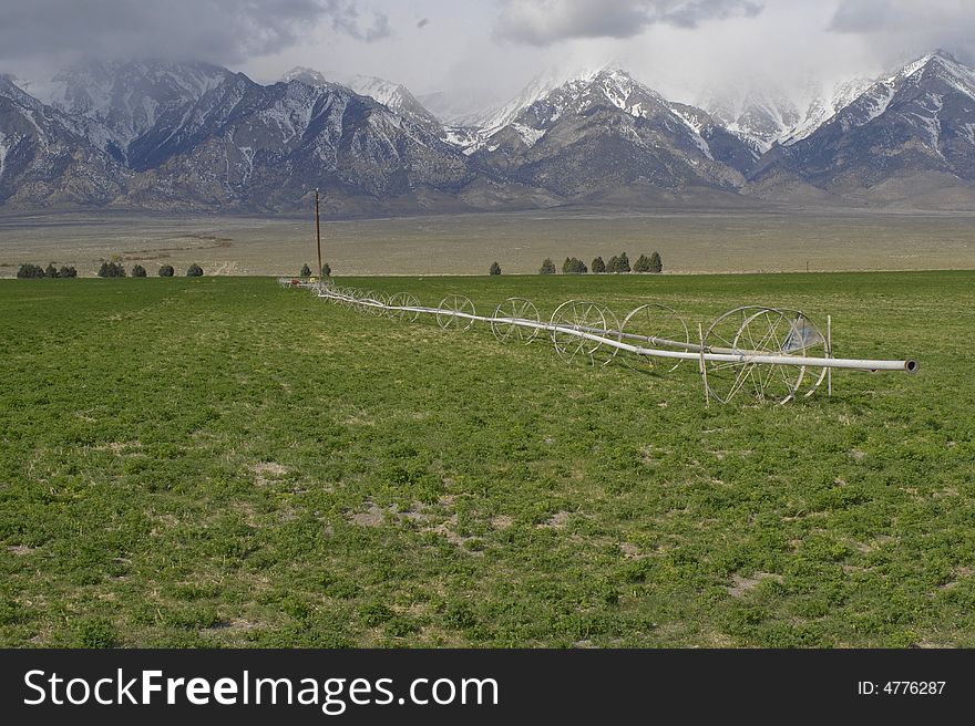 Rolling sprinkler irrigation equipment on a farm along the eastern Sierra Nevada Mountains in California