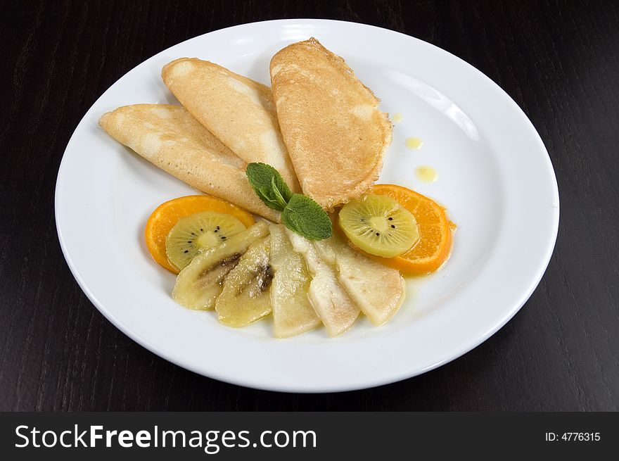 Pancakes with fruit on a white plate. Pancakes with fruit on a white plate.