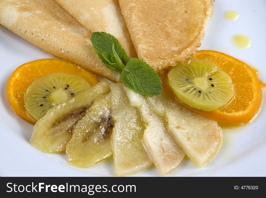 Pancakes with fruit on a white plate. Pancakes with fruit on a white plate.