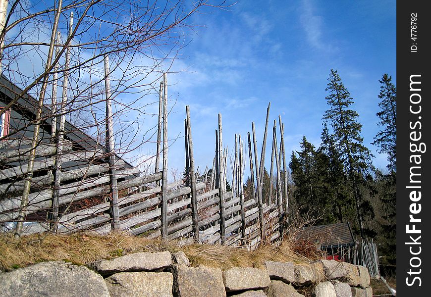 Wooden fence on stone wall