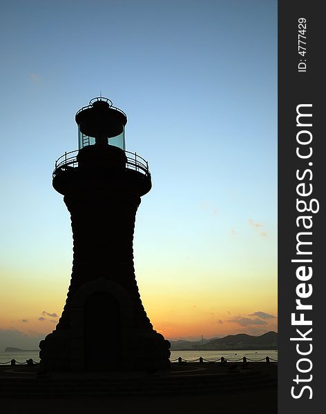 An ornamental lighthouse in sunset on Xinghai Square Dalian, China.