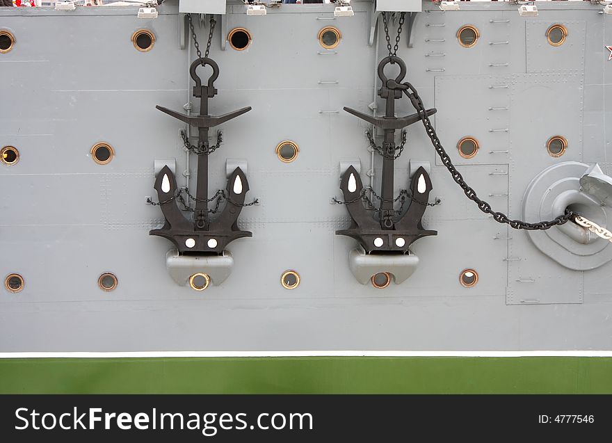 Two anchors, chains, bow windows at the old big Russian warship - cruiser